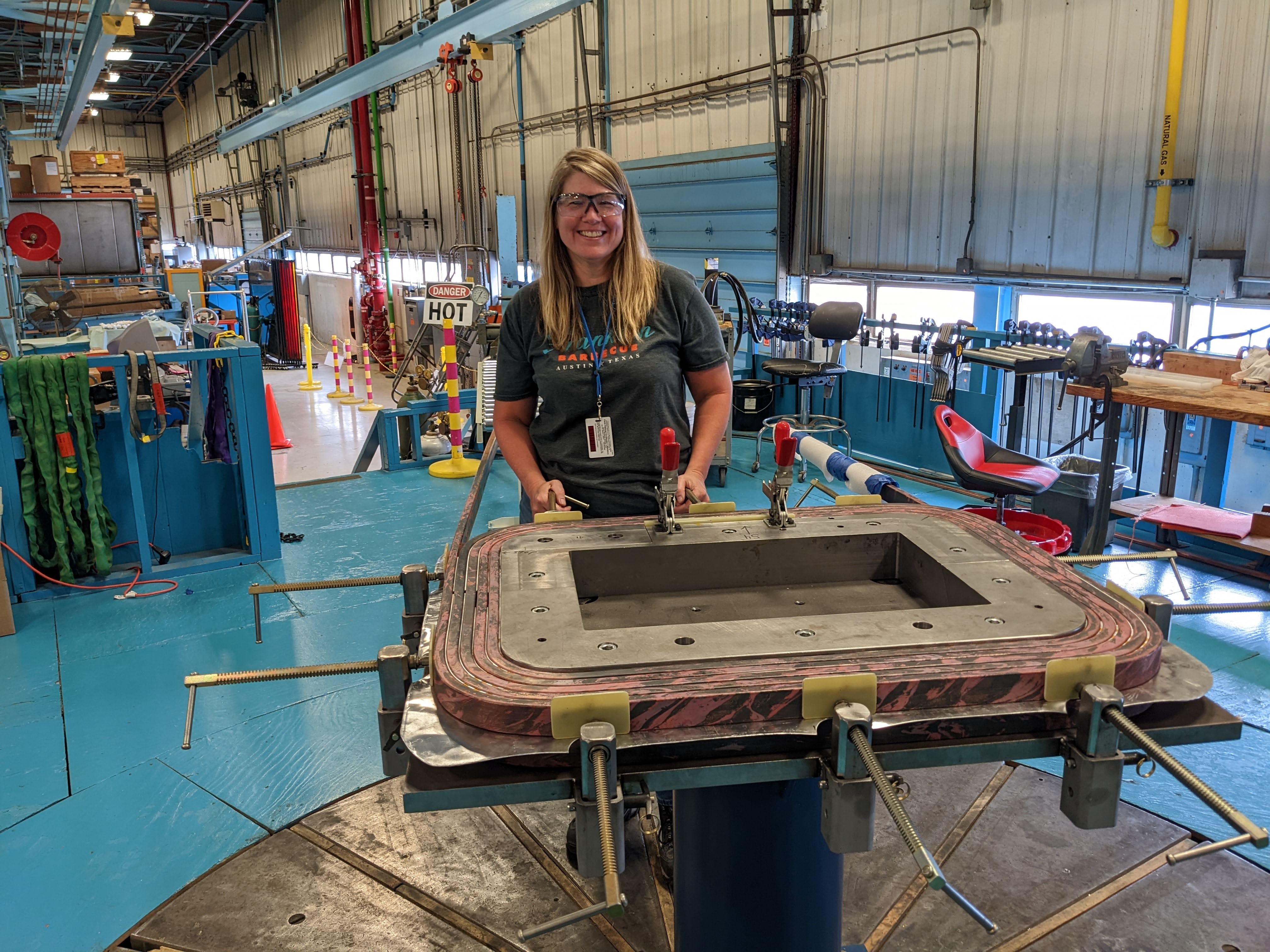 Fermilab lead engineer Sherry Baketz inspects a chicane magnet coil. Credit: Fermilab