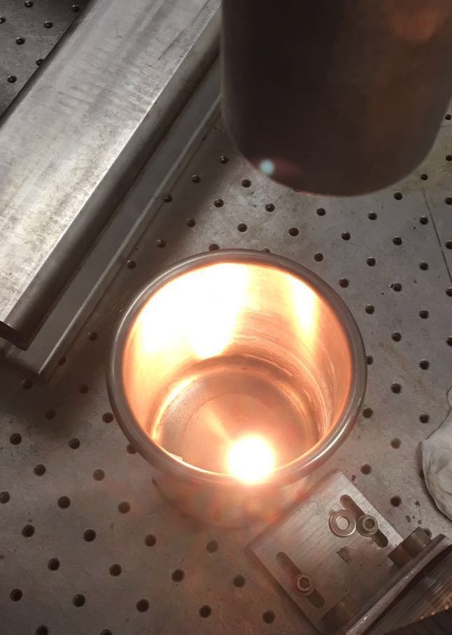 Similar to firing clay in a kiln, a laser is shown “sintering” (strengthening) a ceramic object after the basic shape was produced layer by layer using laser-based melting and resolidification. (Credit: University of Nebraska-Lincoln/Xiang Zhang)