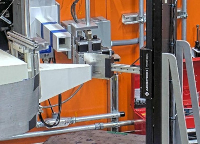 Large industrial neutron diffractometer inside a bright yellow and orange lab