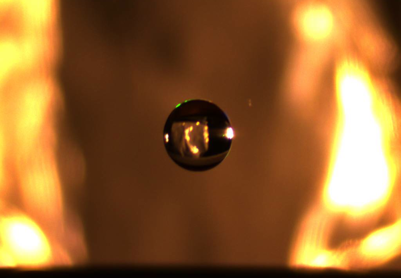 A small droplet of water is suspended in midair via an electrostatic levitator that lifts charged pa