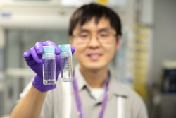 ORNL’s Christopher Lam holds two samples of polymer gels (Credit: ORNL/Genevieve Martin)