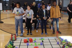 Kids showing their robotics skills at a competition 