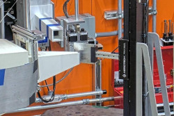 Large industrial neutron diffractometer inside a bright yellow and orange lab