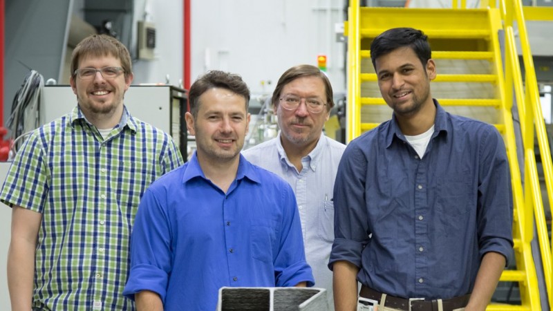 Researchers from the DOE Manufacturing Demonstration Facility located at ORNL used neutrons to test residual stress in 3D-printed steel parts. By studying complex geometries like the figure 6 shown here, researchers can design and build more complex structures with large-scale 3D metal printing. Pictured from left, Jeffrey Bunn, Andrzej Nycz, Mark Noakes, and Niyanth Sridharan. (Credit: ORNL/Genevieve Martin)