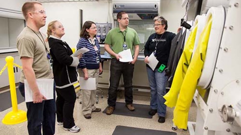 Rhonda Moody (far right) trains scientific associates in the nanomaterials lab. The associates support users and staff at the instrument beam lines.