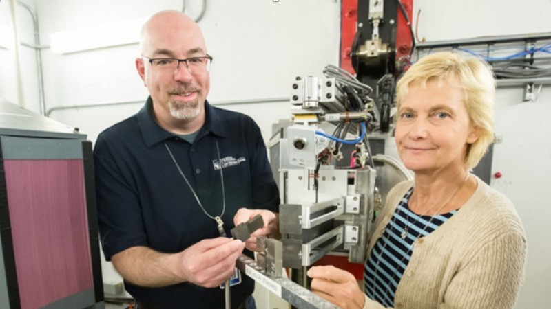 Robert Carter from NASA's Glenn Research Center (left) and Daira Legzdina from Honeywell Aerospace  examined high-temperature nickel alloy samples containing linear friction welds. Image credit: ORNL/Genevieve Martin