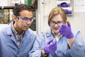 Caltech researchers Orland Bateman (left) and Rachel Ford prepare samples before using neutrons to study a novel form of mixed matrix membrane. (Credit: ORNL/Carlos Jones)