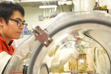 Yu Song, a researcher with the University of California–Berkeley, is shown preparing copper-doped samples of iron telluride, which were shown via neutron scattering at ORNL to have significantly altered magnetic properties. This research could help lead to faster and more efficient electrical systems and electronic devices. (Credit: ORNL/Genevieve Martin)