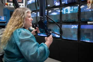 Technical manager Linda Farr leads the remote handling team responsible for monitoring and replacing essential equipment for daily operations at Oak Ridge National Laboratory’s Spallation Neutron Source. Robotic arms called “servomanipulators” allow her to handle this equipment from a central control room. (Image credit: ORNL/ Genevieve Martin) 
